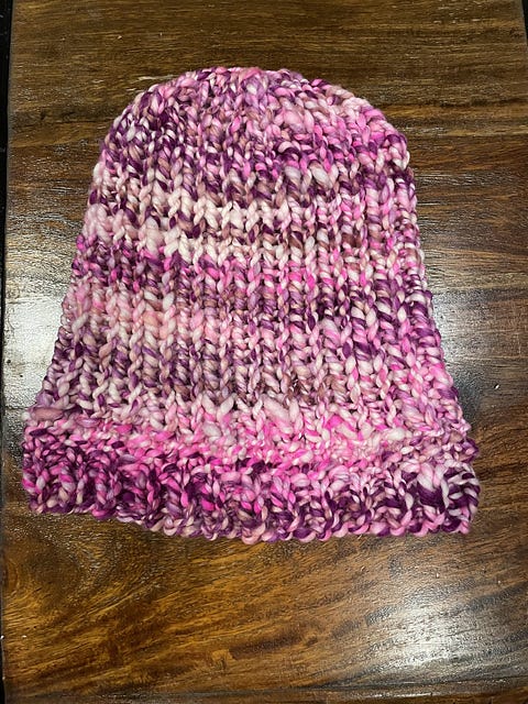 A knitted hat on a table.